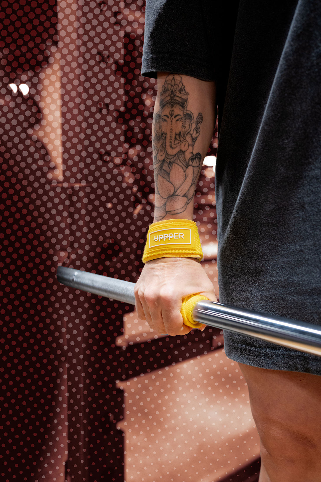 woman gripping barbell with uppper lifting straps